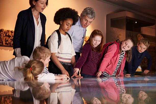 istock Pupils On School Field Trip To Museum Looking At Map 538358394