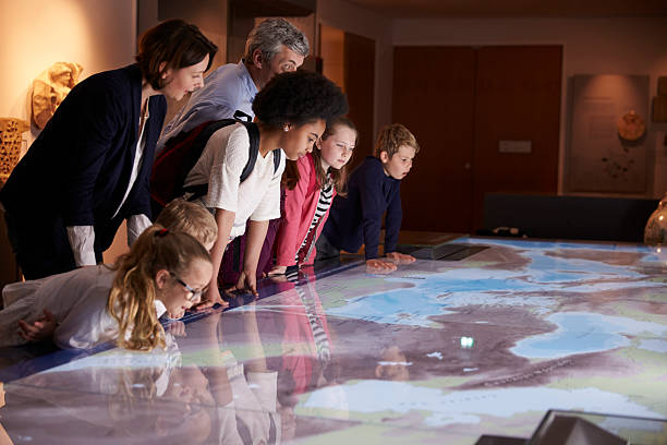 istock Pupils On School Field Trip To Museum Looking At Map 538358434