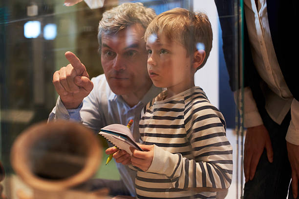 istock Father And Son Look At Artifacts In Case On Trip To 538358768