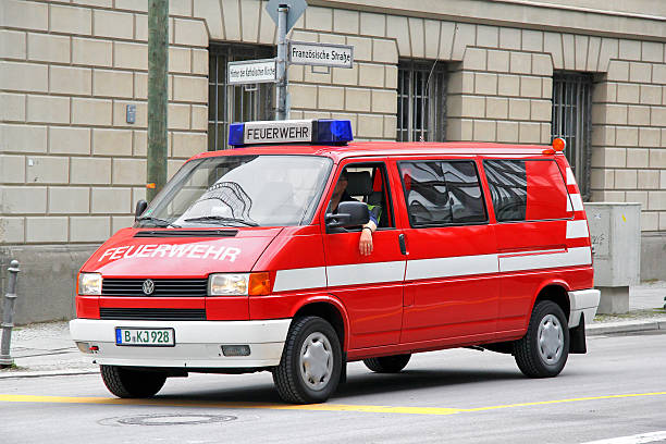 Volkswagen Transporter Berlin, Germany - September 12, 2013: Red Volkswagen Transporter firetruck drives at the city street. car transporter truck small car stock pictures, royalty-free photos & images