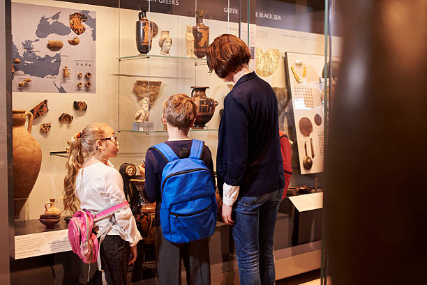 istock Teacher And Pupils Looking At Artifacts On Display In Museum 538358858