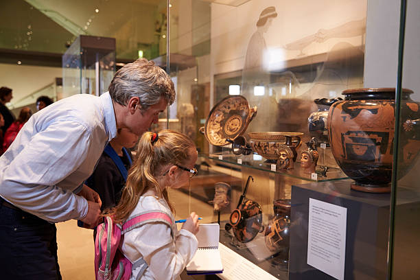 istock Teacher And Pupils Looking At Artifacts On Display In Museum 538358972