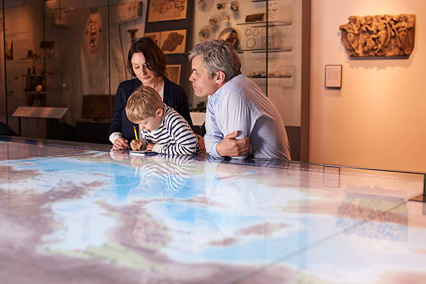 istock Family On Trip To Museum Looking At Map Together 538358974