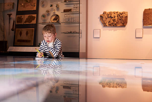 istock Boy On Trip To Museum Looking At Map And Writing In 538358988