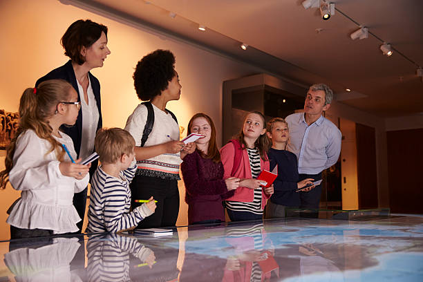 istock Pupils On Trip To Museum Looking At Map And Making 538359254