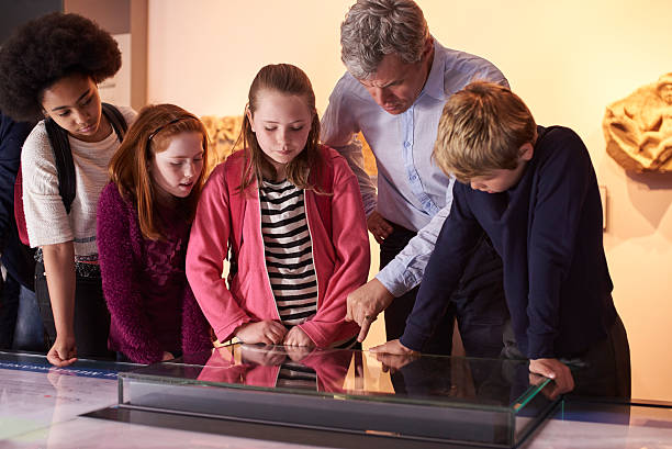 istock Pupils On School Field Trip To Museum Looking At Map 538359278