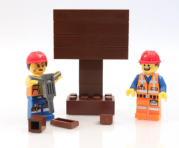 lego-строительных рабочих с знак - lego toy close up characters стоковые фото и изображения