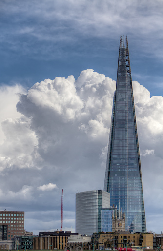 London, United Kingdom - May 23, 2004: The Shard of Glass Skyscraper dominating the London citiscape. Designed by Italian architect Renzo Piano has 95 storeys over a height of 309.6 metres .
