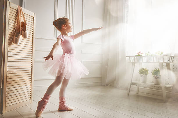 girl in a pink tutu Cute little girl dreams of becoming a ballerina. Child girl in a pink tutu dancing in a room. Baby girl is studying ballet. ballet stock pictures, royalty-free photos & images