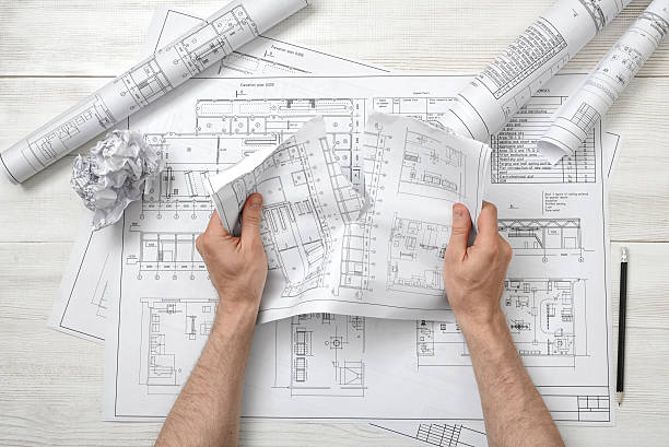 istock Close-up hands of architect tearing a bad drawing 538361504