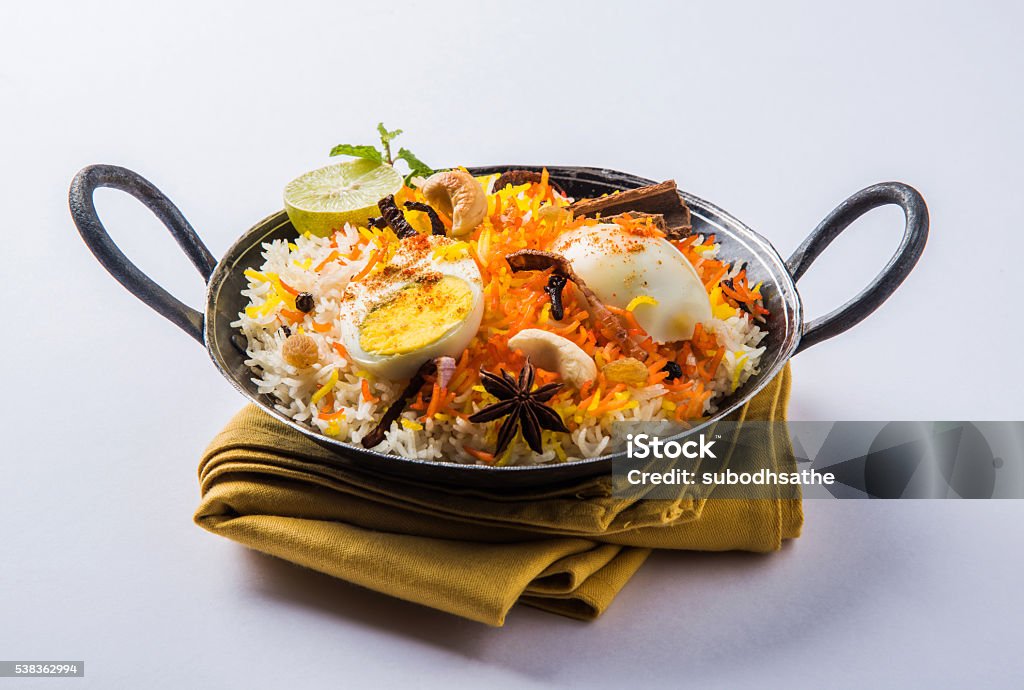 egg biryani or anda biryani using basmati rice and spices Basmati rice slowly cooked with Masala roasted egg and spices served in kadhai or kadai with yogurt dip, selective focus, egg biryani or anda rice or egg rice Animal Egg Stock Photo