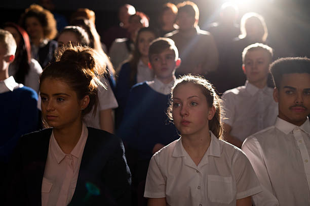 Crowd of Students Crowd of teenage students in a lecture hall. They are looking towards the speaker, who can't be seen. theater class stock pictures, royalty-free photos & images
