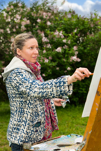 istock Female dreamy painter during an art class in a park 538366460