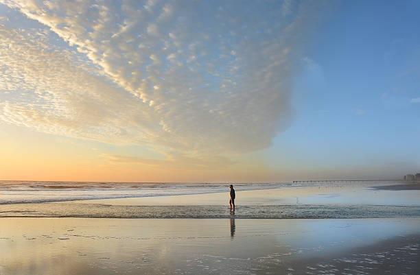 istock Man walking on the beach at beautiful sunrise. 538368086