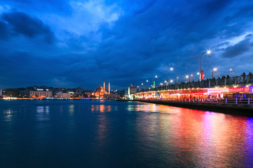 New Mosque and Galata Bridge view at night from Karakoy, Istanbul, Turkey.