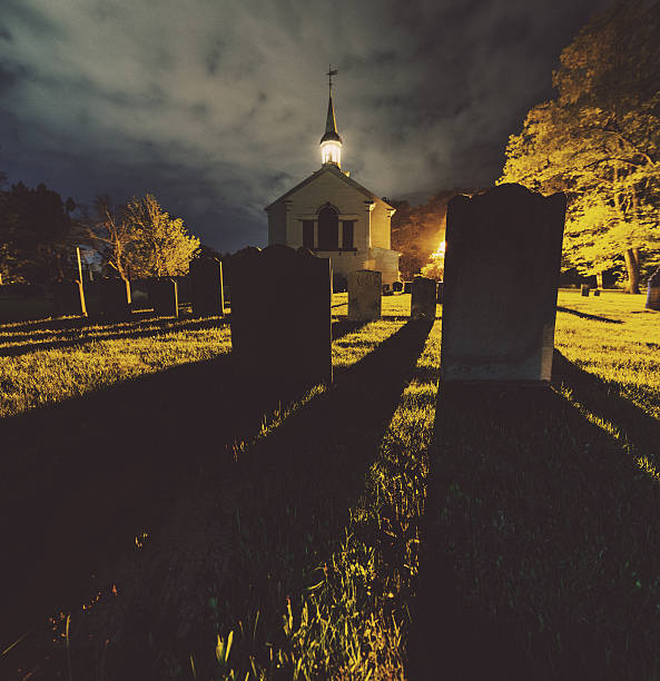 The long shadows of 19th century headstones sweep across a cemetery.  Long exposure.