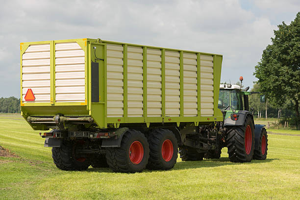 istock transport of cut grass with tractor and loader wagon 538368930