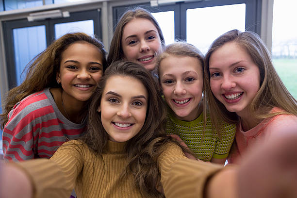 Selfie with the Girls Five teenage students taking a selfie in school. teenagers only teenager multi ethnic group student stock pictures, royalty-free photos & images