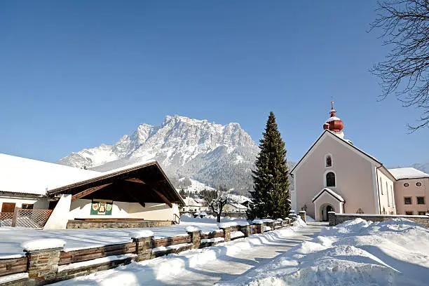 Parish church in Ehrwald with Zugspitze summit, Germany's highest mountain