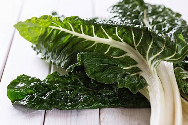 Bunch of silverbeet on a rustic wooden background stock photo