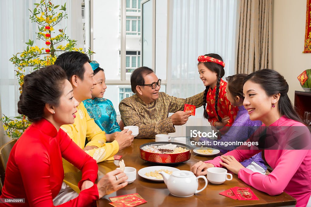 Tet celebration Asian family enjoying Tet celebration at home Family Stock Photo