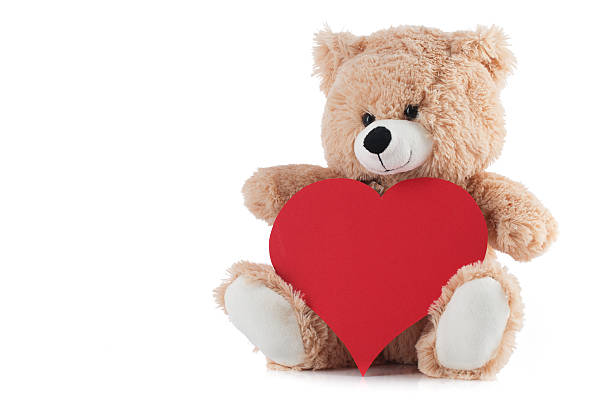 istock Teddy Bear Holding a Heart on white 538408389