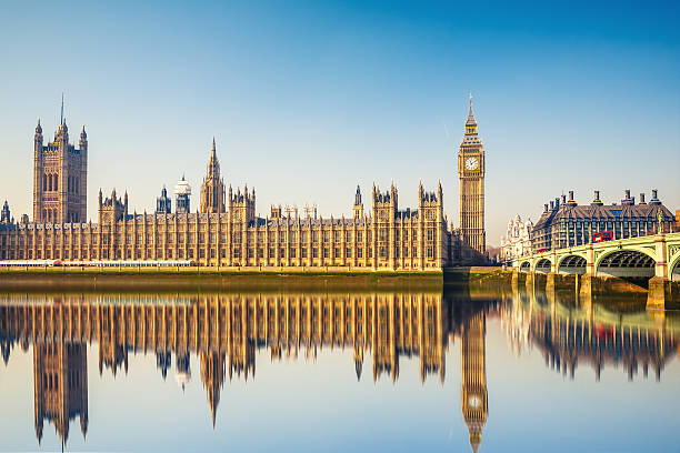 Big Ben and Houses of parliament, London Big Ben and Houses of parliament at calm sunny morning houses of parliament london stock pictures, royalty-free photos & images