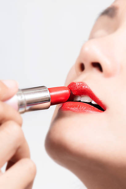 istock Beauty Girl applying lipstick 538411147