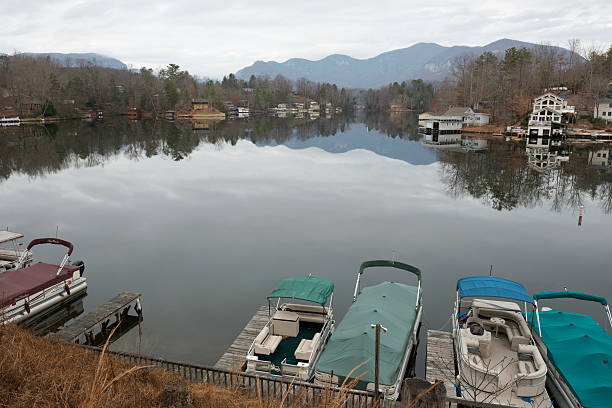 Homes, boats, and landscape reflected in the water at Lake Lure, North Carolina