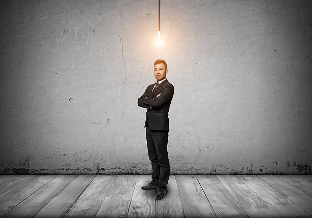 istock Smiling businessman looking at the camera with glowing bulb over 538446526