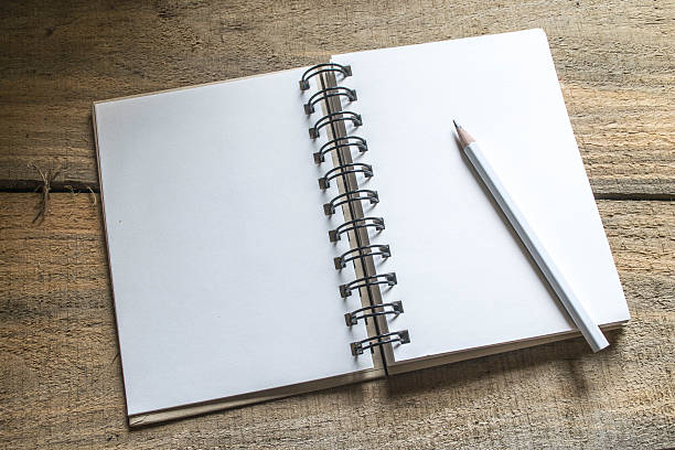istock note book , pencil on old wooden 538446687