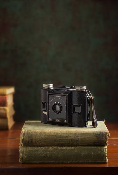 istock Vintage film camera from 1920s sitting on stack of books 538446699