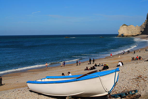 Etretat village, bay beach and boats on a foggy night. Normandy, France, Europe.