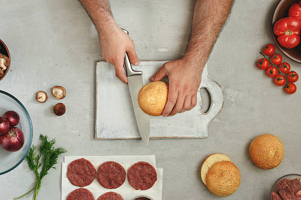 istock Male cook is preparing burgers 538447632