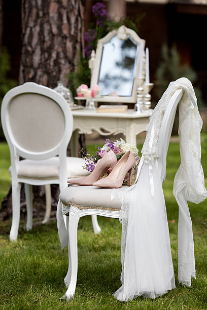 bride set of bouquet and shoes on the vintage chair stock photo