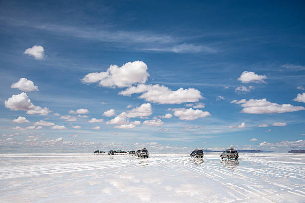 Cars at the desert Cars at the desert - Salar de Uyuni in Bolivia salt flat stock pictures, royalty-free photos & images