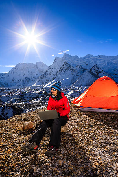 istock Young woman using laptop in Himalayas, Nepal 538449189