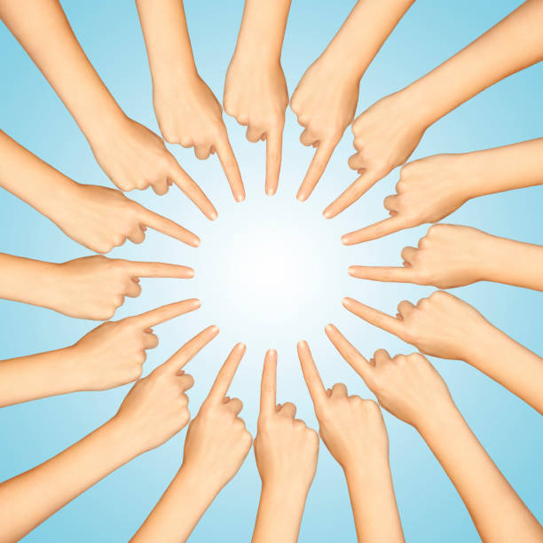 istock Sixteen Fingers Pointing Toward A Center 538449333