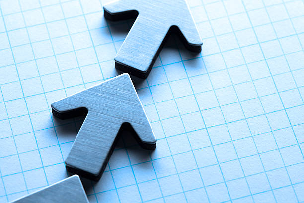 istock Row Of Arrows On Graph Paper 538452524