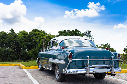American classic car parked under blue sky in cuba
