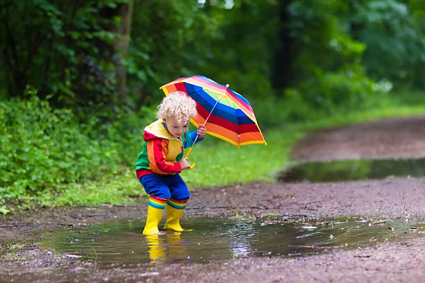 istock Cute child playing in the rain 538455326