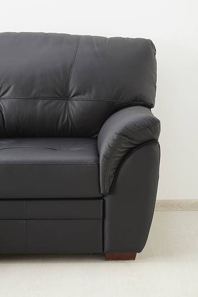 istock Black brown leather sofa against the wall 538459738