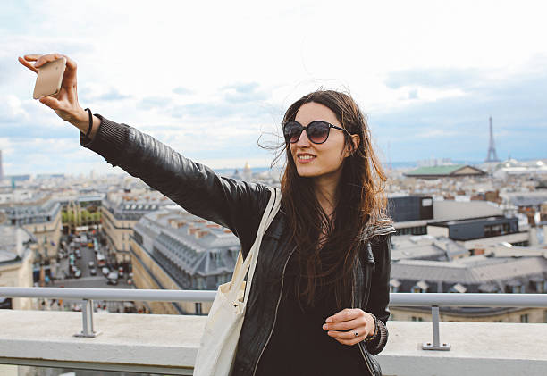istock Young Parisian woman taking a selfie in Paris 538460328