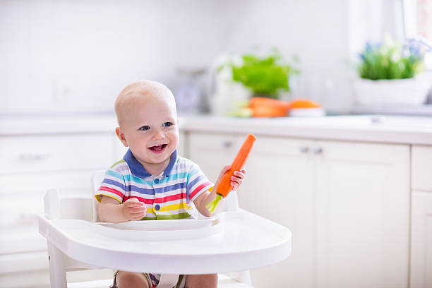istock Little baby eating carrot 538460336