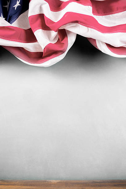 istock American education. USA flag, school classroom chalkboard, desk. 538462444