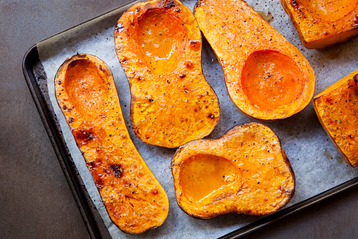 Roasting butternut pumpkin, for a warming soup.  Top view on oven tray.