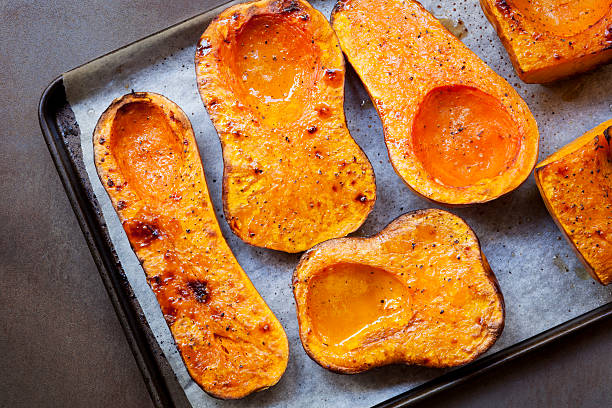 Roasting Butternut Pumpkin for Soup Roasting butternut pumpkin, for a warming soup.  Top view on oven tray. pumpkin soup photos stock pictures, royalty-free photos & images