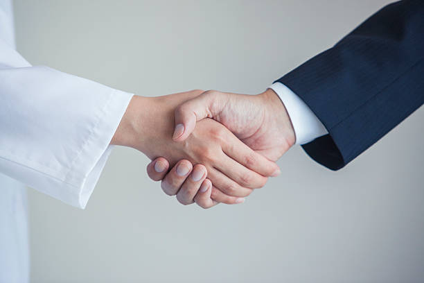 istock Doctor and businessman shaking hands 538465136