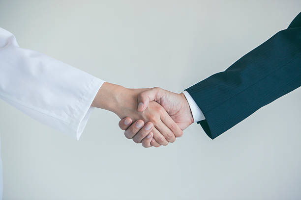 istock Doctor and businessman shaking hands 538465238