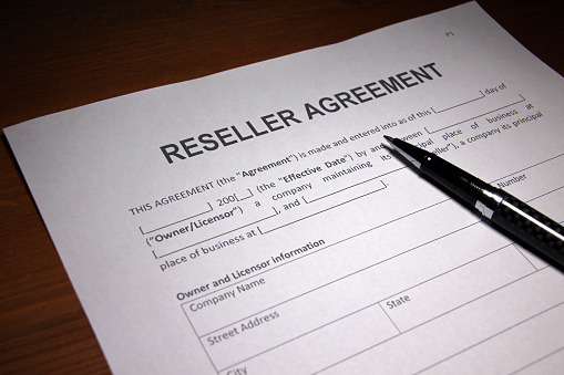 Someone filling out Reseller Agreement.